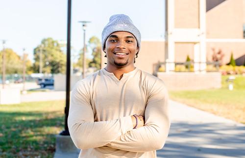 person standing in front of bell tower at SBU